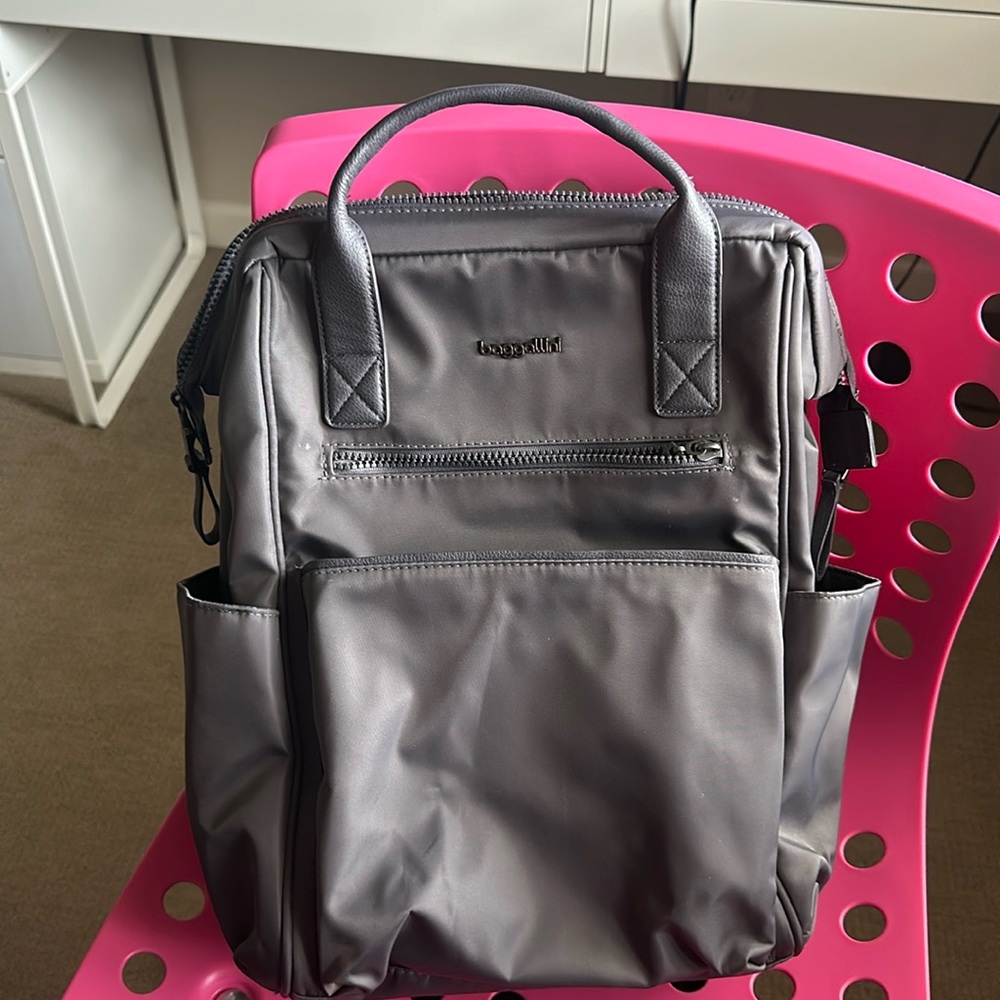 Smaller 15”L x 11.5”D x 6”D, gray baggallini backpack. Used one time.